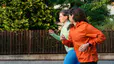 Two women jog together, practicing zone 2 cardio