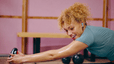 Happy woman completes a feel good workout with Peloton