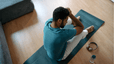Tired man sitting on a yoga mat