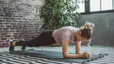 Woman does a forearm plank, 1-minute plank every day