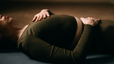 Photo of woman's torso as she reclines on the floow in Savasana yoga pose 