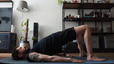 Man doing Bridge Pose in yoga for core strength in his living room
