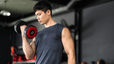 Man does a bicep curl exercise with a dumbbell