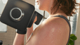 Woman holding dumbbells while doing a superset during a Peloton strength workout