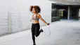 Woman jumping rope outdoors, an example of cardio without running 