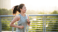 A woman going for a run in the morning outside.