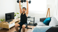 Man lifts weights at home