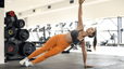 Woman doing side plank in gym