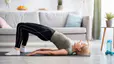 Woman practices a Bridge yoga pose