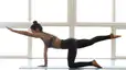 Woman does a bird dog, a deep core exercise