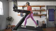 Woman runs on Peloton Tread+ at home