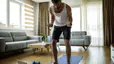 Man working out at home with resistance bands and weights 