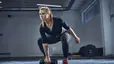 Woman doing a dumbbell snatch exercise 