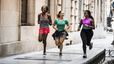 Group of women running through urban area