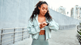 A woman in workout clothes checking her heart rate variability with the help of a smartwatch.