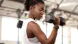 Woman lifts weights at gym