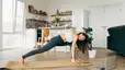 Woman practices Pilates class at home 