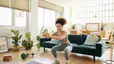 Young woman does squats in living room 