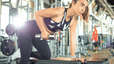 Woman lifting weights at a gym