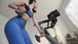 Woman training with Peloton wearing an integrated wearable