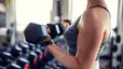 Woman lifting weights at gym 