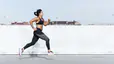 Woman does sprints outside while doing interval training