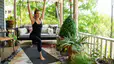 Woman does a yoga workout on patio 
