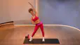 Ally Love demonstrates an ab stretch in a Peloton class