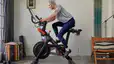 Woman riding a Peloton Bike
