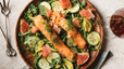 An aerial view of a healthy watercress salad with salmon.