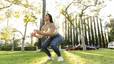 Woman does a jump squat outdoors 