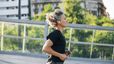 A mid-age woman running outside on a sunny day.