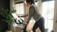 Woman on Peloton Bike looks at screen 