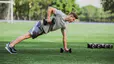 Andy Speer doing a renegade row in a push up position