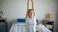 Woman stretching on bed