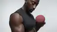 A man lifting a dumbbell in a bicep curl.