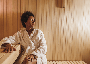 A woman relaxing in the sauna after a workout. 