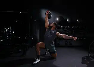 Dre Mayes demonstrates a kettlebell exercise  