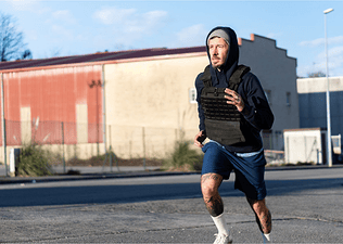 Man running in a weighted vest