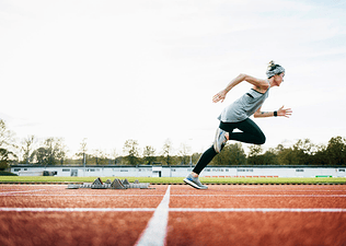 Woman sprinting on an outdoor track