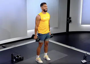 Rad Lopez demonstrates lateral raises in Peloton class