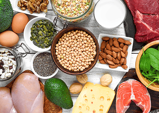 A flay-lay photo of various sources of protein you can eat to gain muscle.