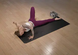 Peloton instructor Kirra Michel demonstrates the scorpion stretch.