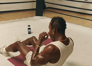 Man doing sit ups in a boxing ring as a way to strength train without weights
