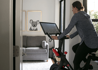 Woman jogs outdoors with her dog.