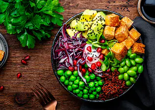 Vegan bowl with tofu, quinoa, vegetables and legumes