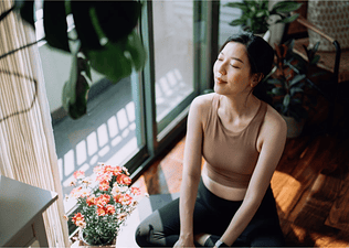 Woman meditating by a window