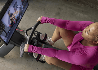 A peloton member exercising on the Peloton Row