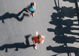 Overhead shot of runners racing a half marathon and preparing for post-half marathon recovery.