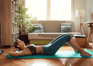 Woman does a sit up exercise at home 